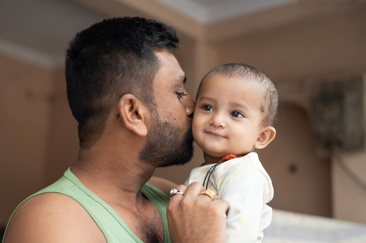 Father lovingly holds his young child in Madhya Pradesh, India