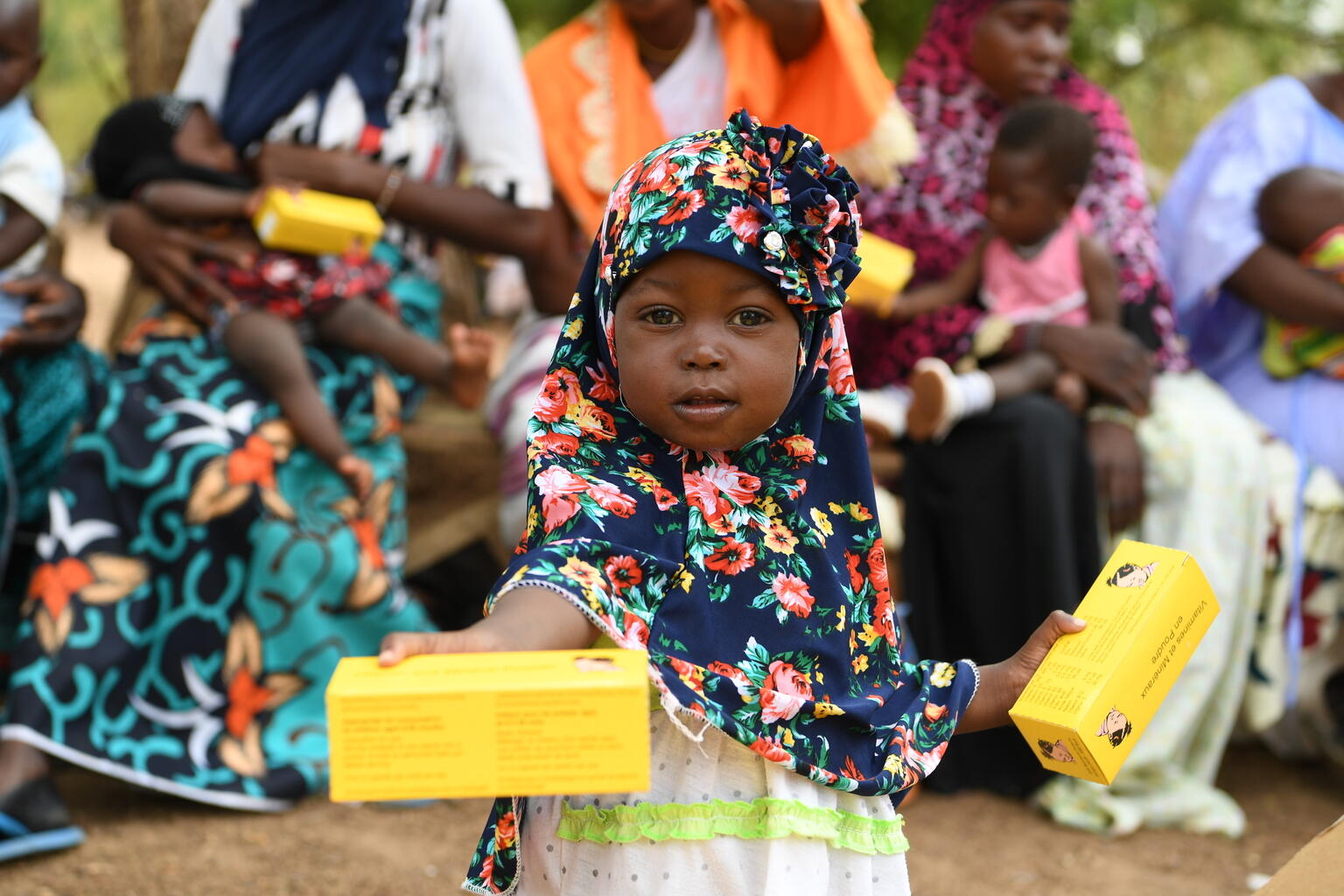 Woman and children at a malnutrition screening session in the village of Ngolo, in the Northern region of Burkina Faso. 