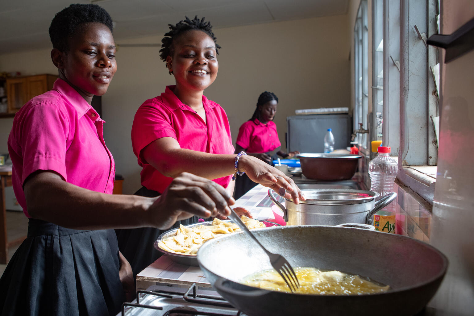 Adolescents cooking together