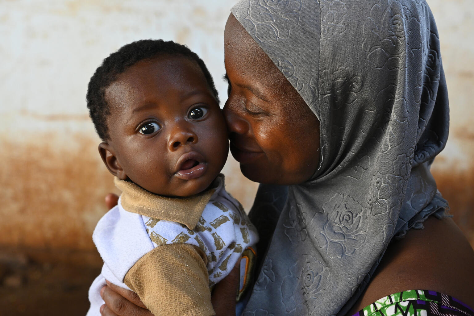 A mother gives affection to her child